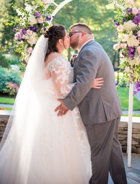 Bride and Groom are kissing at the wedding