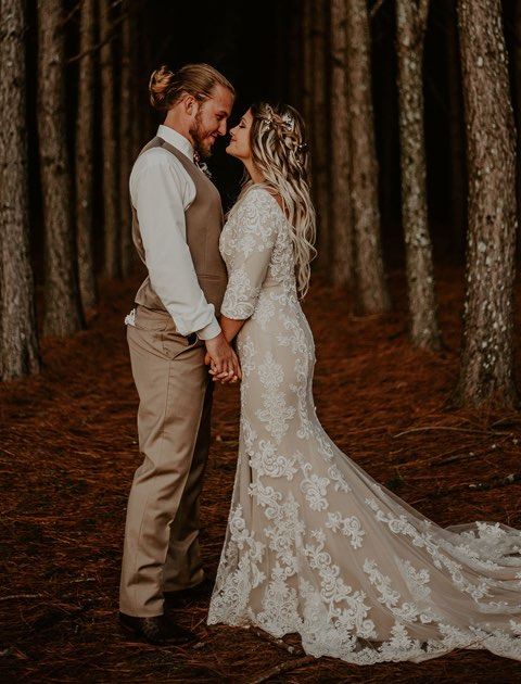 Bride and Groom are staring at each other in the forrest