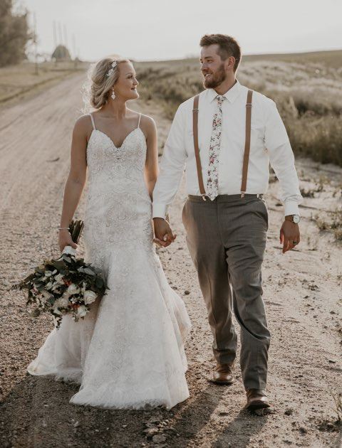 Bride and Groom walking near countryside road